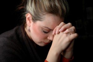 a woman is praying to god with hope