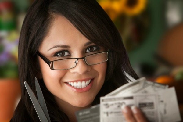 Beautiful Latina Woman at table in Kitchen with Coupons